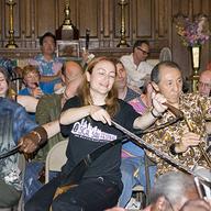 Natalia "The Saw Lady" Paruz performs with 52 other musical saw players in the 2009 NYC Musical Saw Festival, setting a Guinness Record. 